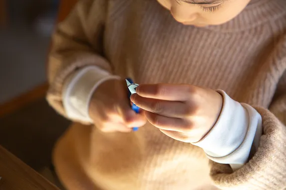 Child cutting a paper shape