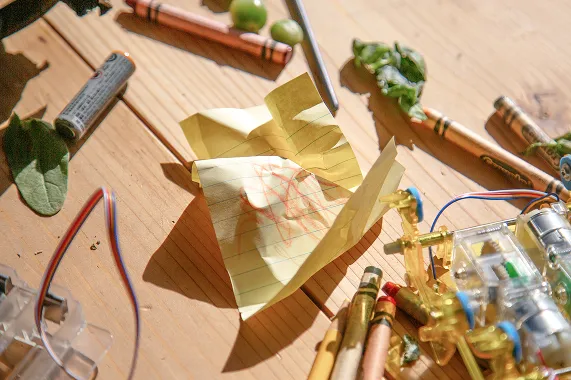 A crumpled up drawing surrounded by in progress work